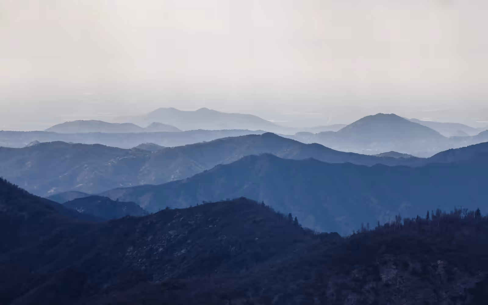 Layered blue mountain ridges of the Southern Oregon coastal range at dusk