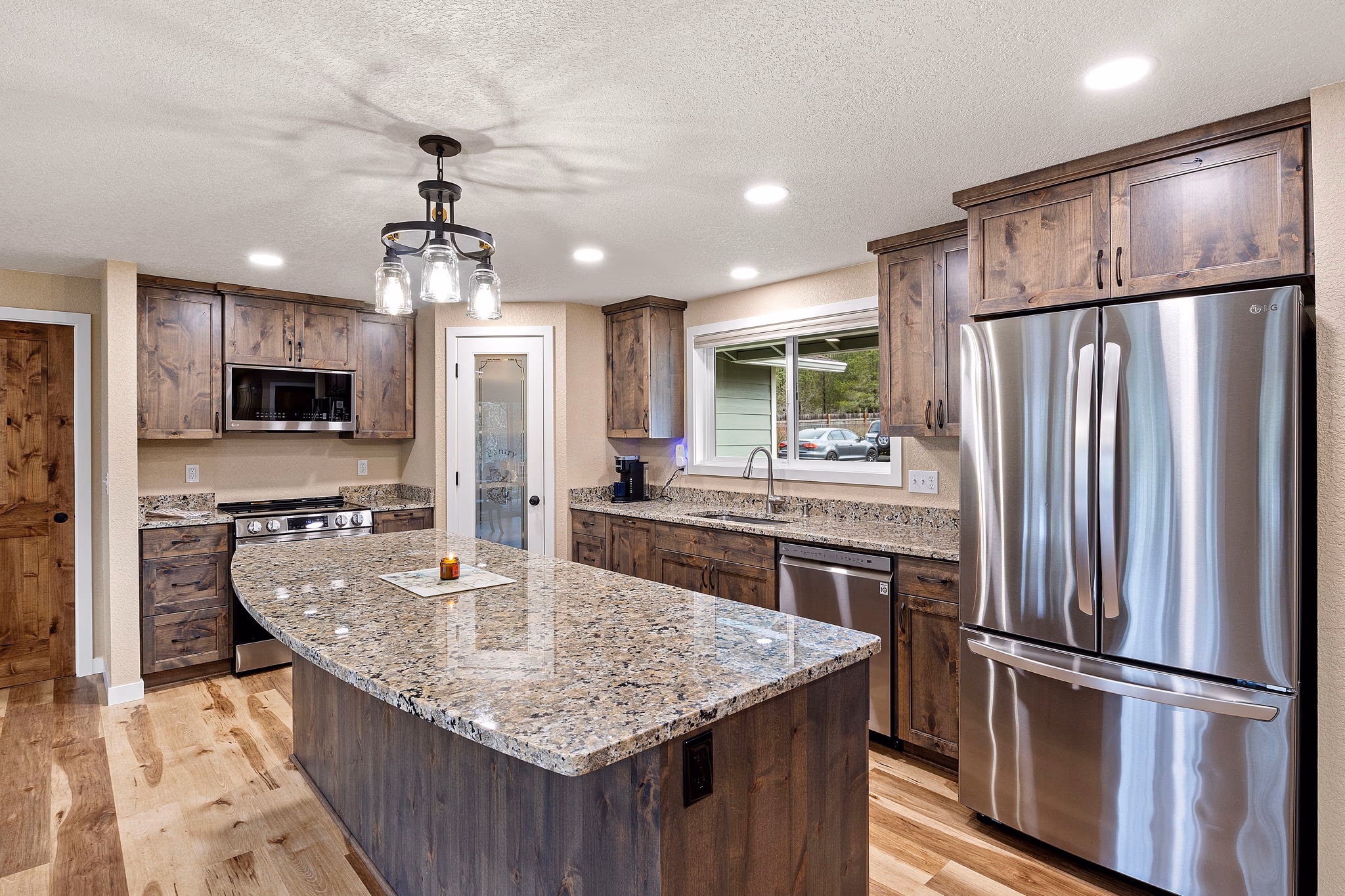 Remodeled kitchen with granite island, stainless appliances, and hardwood floors — Roseburg Oregon home