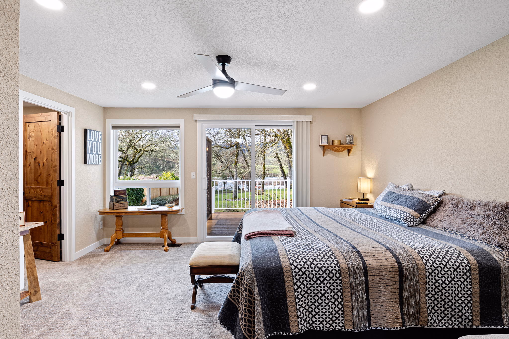 Primary bedroom with patio door access and natural light — Roseburg Oregon home on Echo Drive